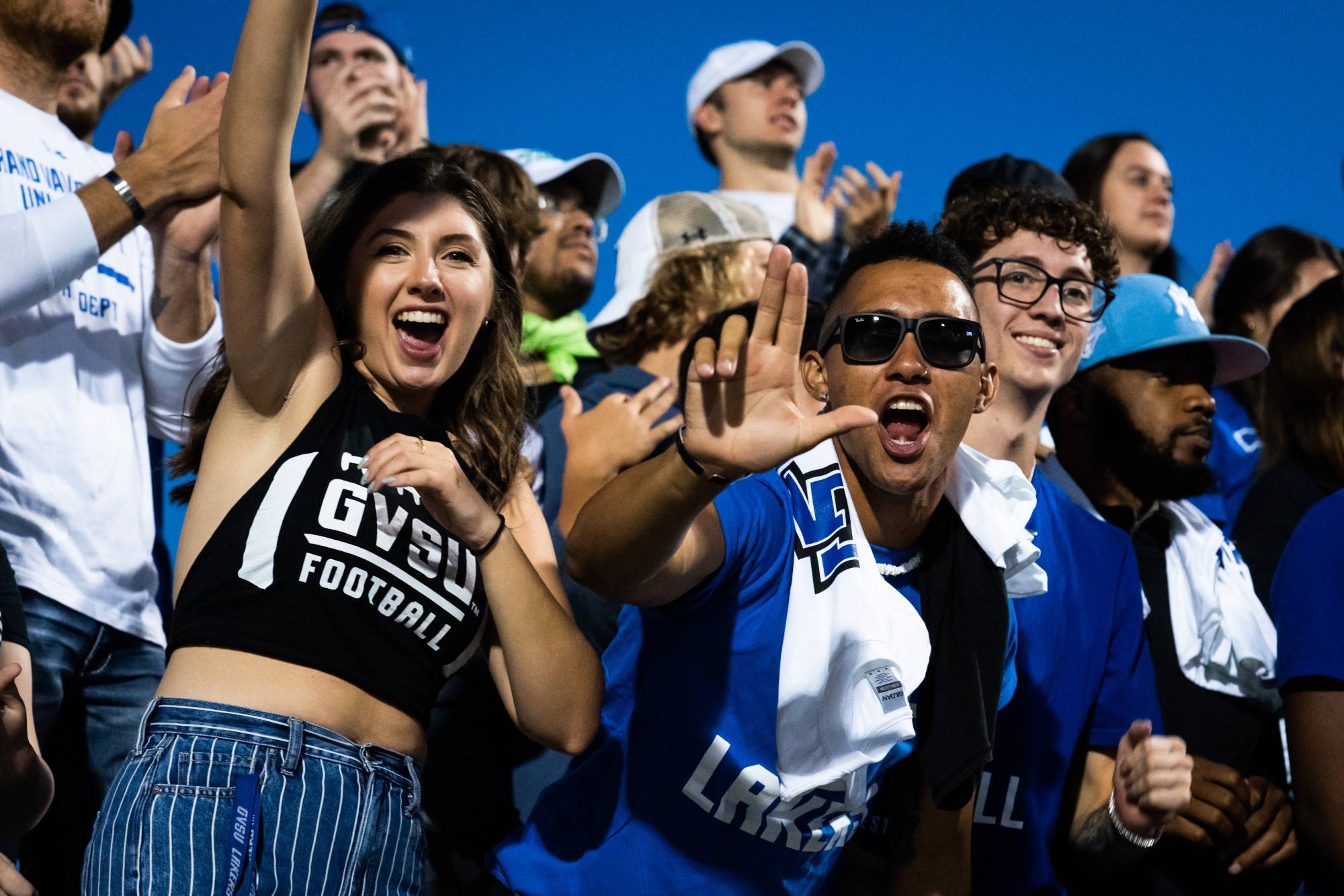 Lakers cheer at Lubbers Stadium in blue and white overalls